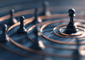 Chess pieces inside different sized circles on a table